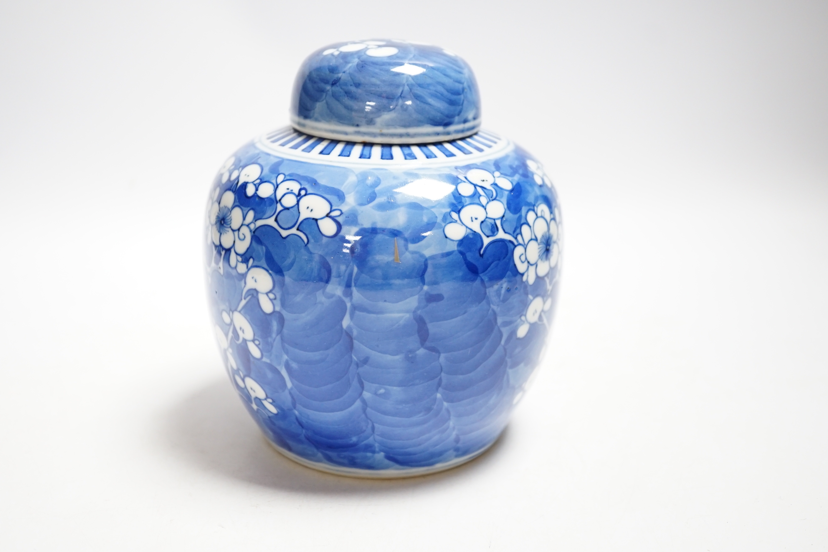 An early 20th century Chinese blue and white prunus jar and cover, 14cm